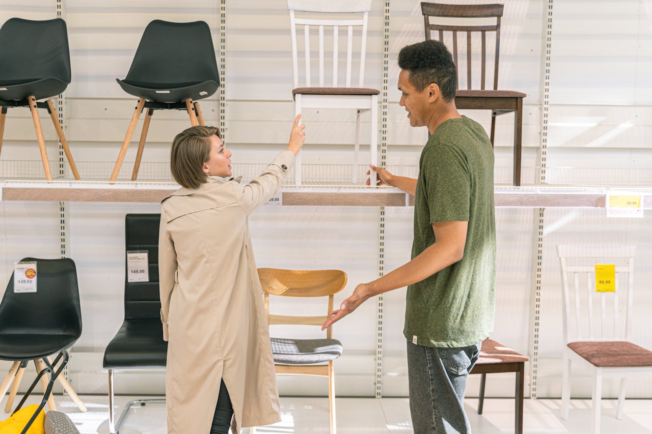 The Art of Drawing Readers In: Your attractive post title goes here A couple explores chair options together in a modern furniture store during the day.
